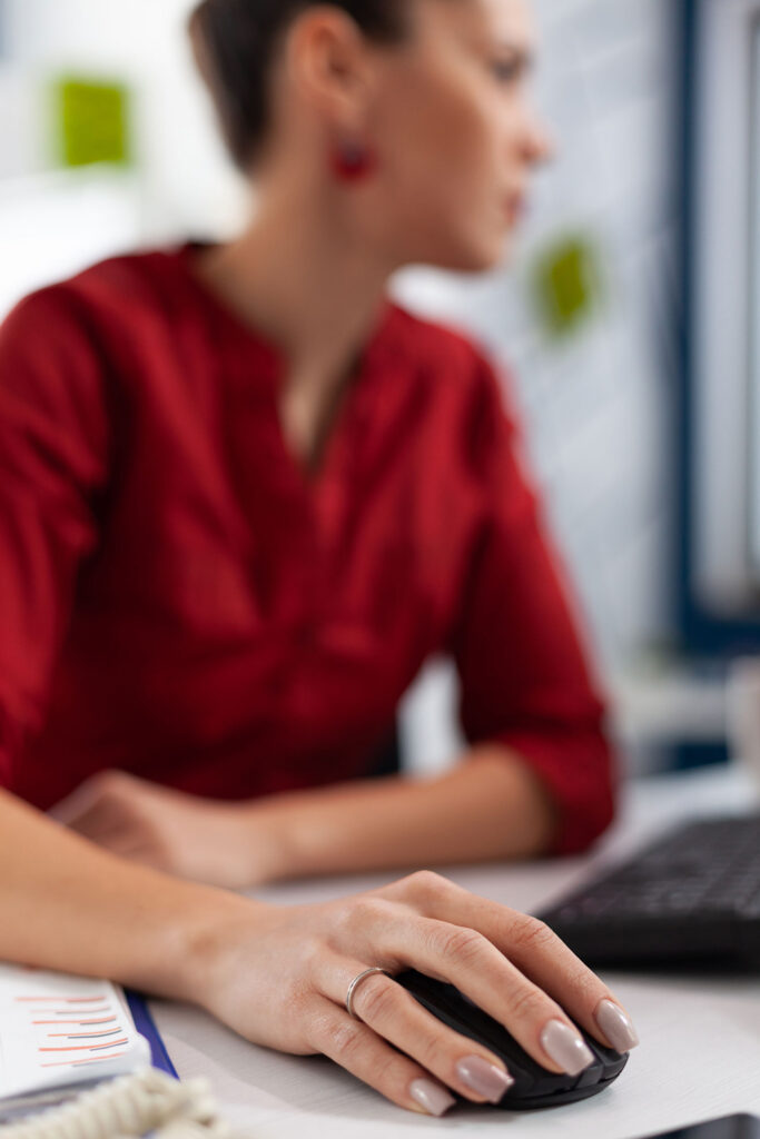 closeup-manager-fingers-with-ring-cliking-desk-startup-office-employee-scrolling-content-desktop-computer-entrepreneur-hand-red-shirt-using-wireless-computer-mouse